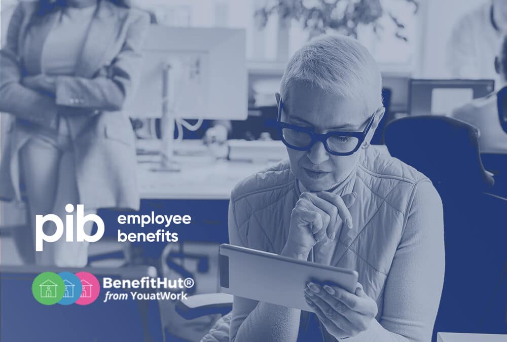 Woman browsing employee benefits on a tablet within the office.