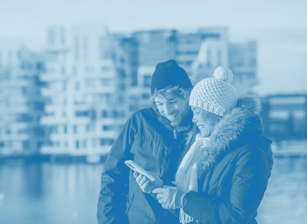 three office people stand and smile, laptop, man and woman, employee benefits