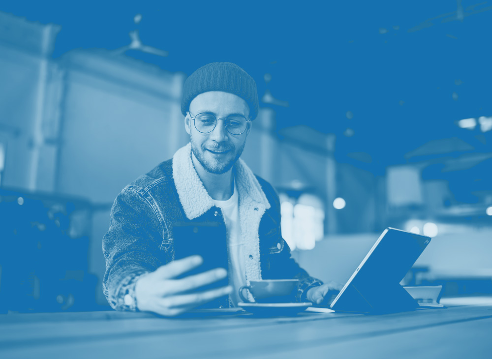 Man smiling looking at phone in home
