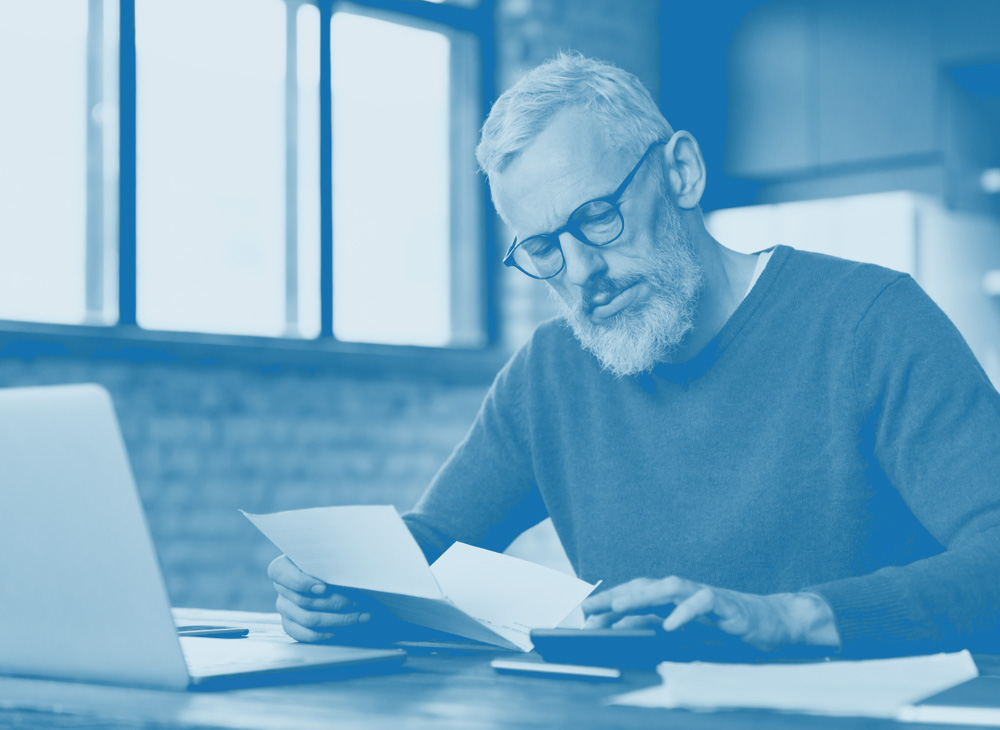 Man smiling looking at phone in home